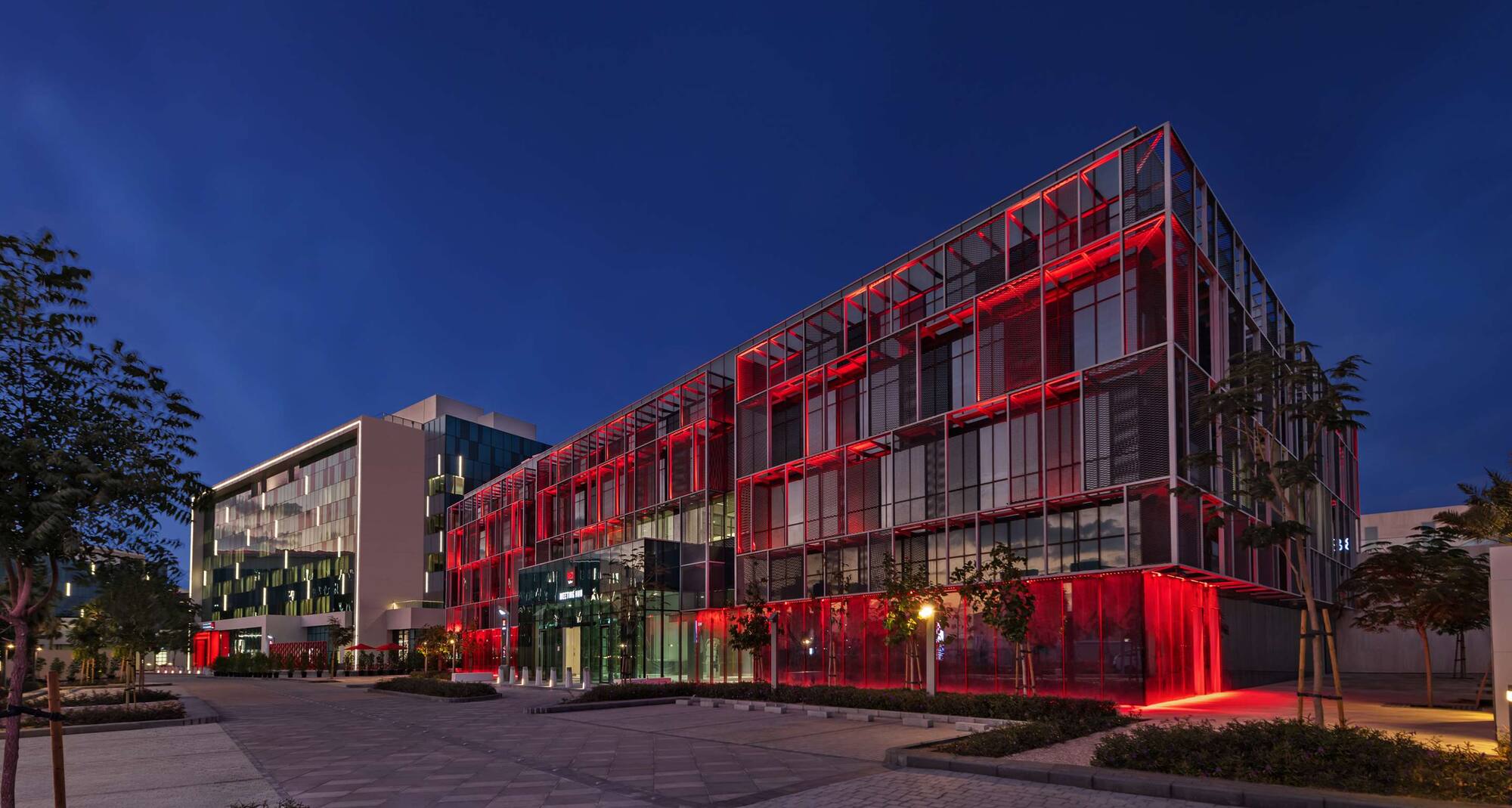 Radisson RED hotel lit red at night, Dubai Silicon Oasis